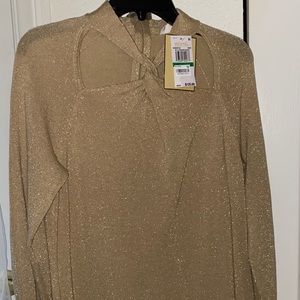 A gold metallic sweater dress